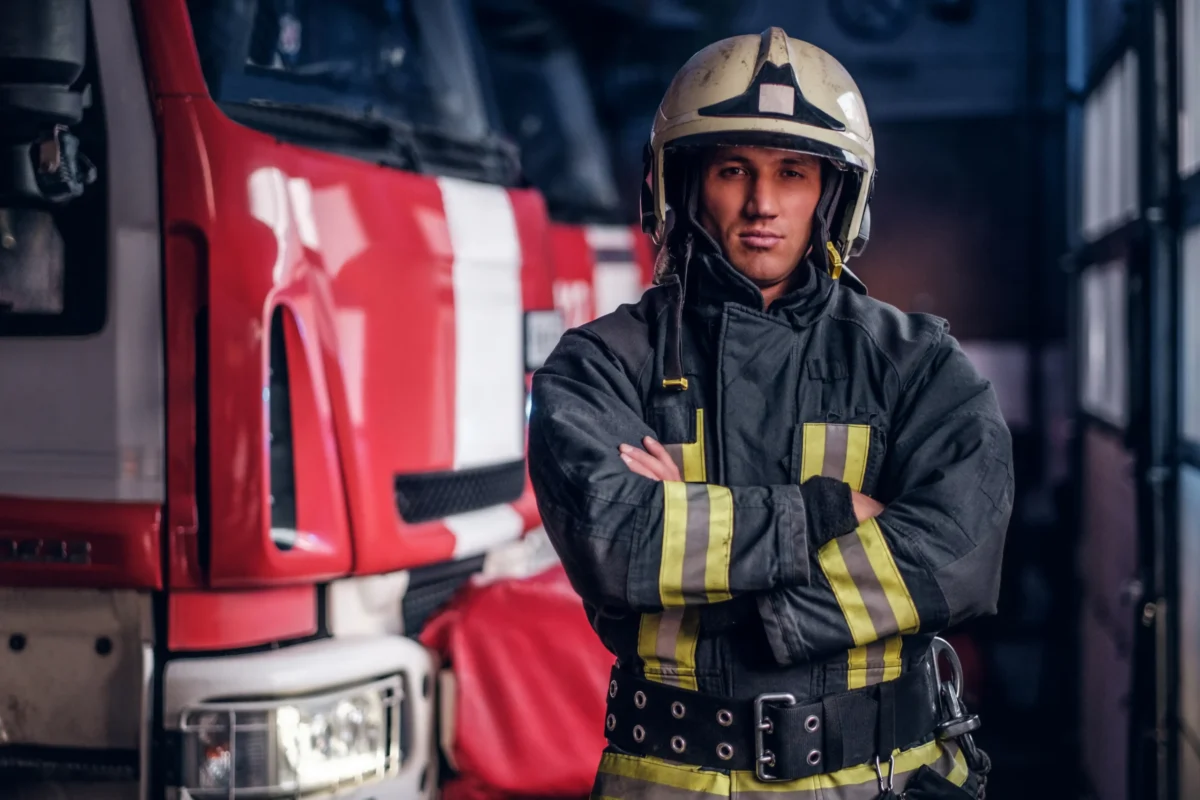 fireman-wearing-protective-uniform-standing-next-t-2026-03-17-03-33-54-utc-scaled.webp